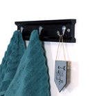 Bath towel hanging on Black Pine coat and hat hanger with 3 chrome hooks