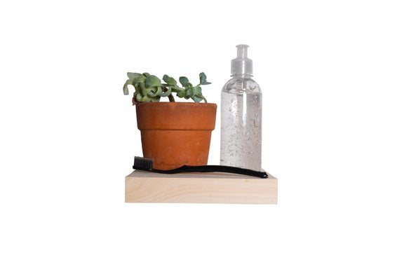 Raw Pine floating shelf with sanitiser and toothbrush on top